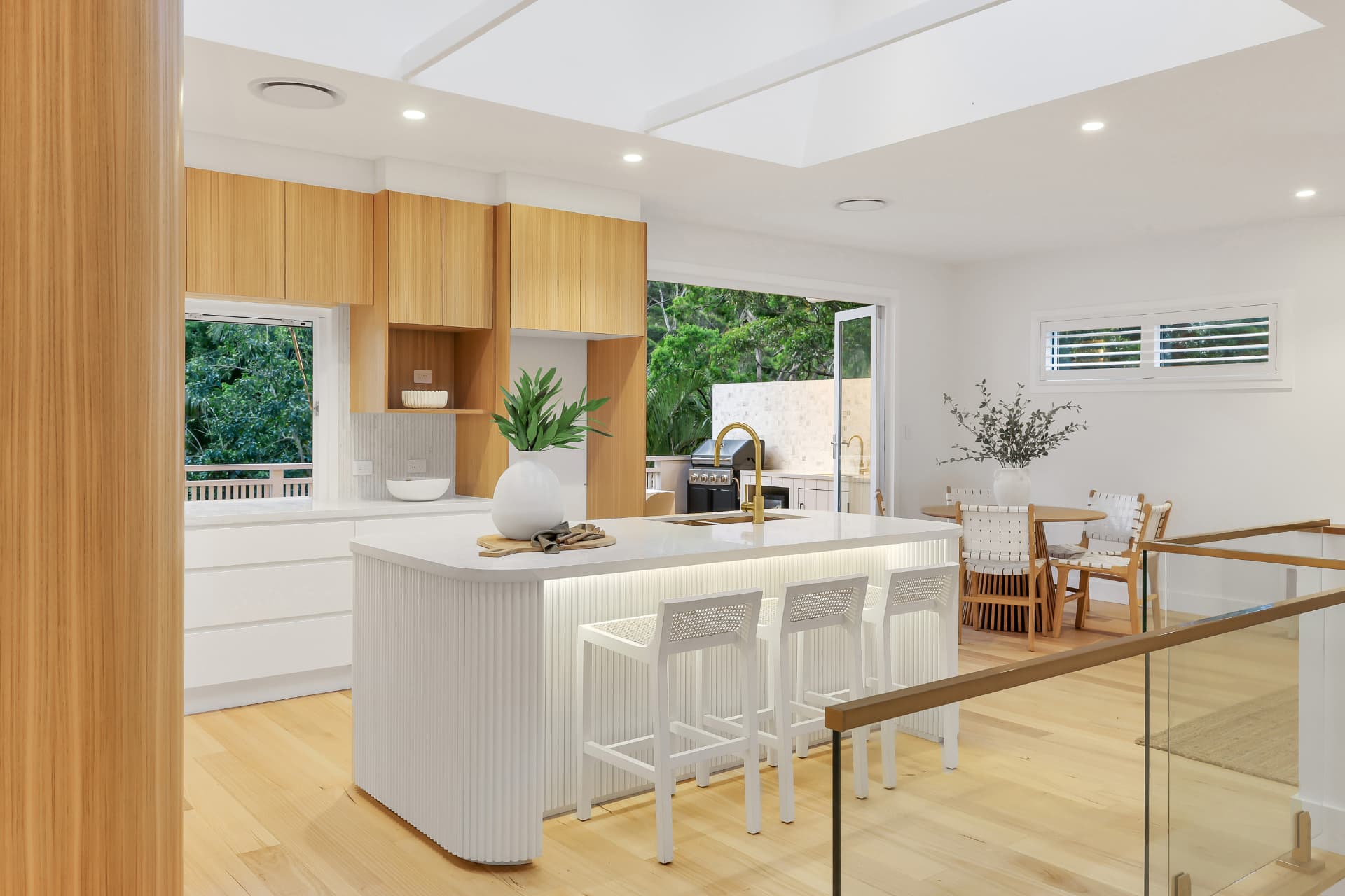 Kitchen and dining opening onto a deck — real estate photography by Estate Media Co