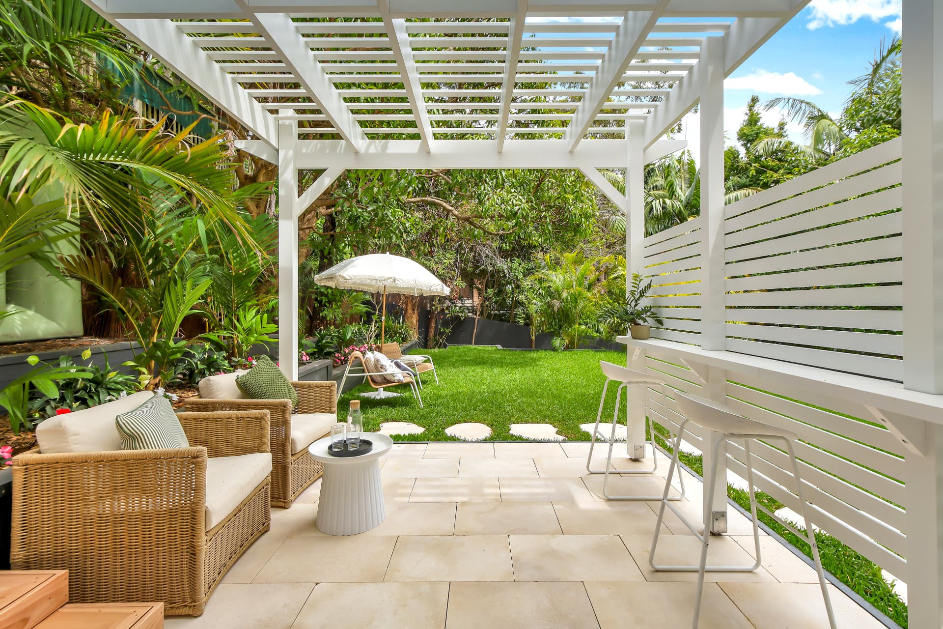 Covered pergola and lawn outdoor entertaining area — real estate photography by Estate Media Co