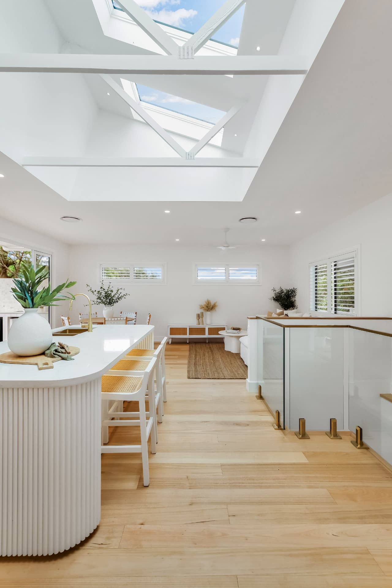 Skylit kitchen island and living space — real estate photography by Estate Media Co
